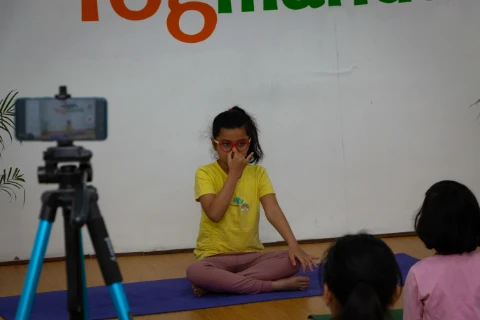 Little girl performs Alternate Nostril Breathing.
